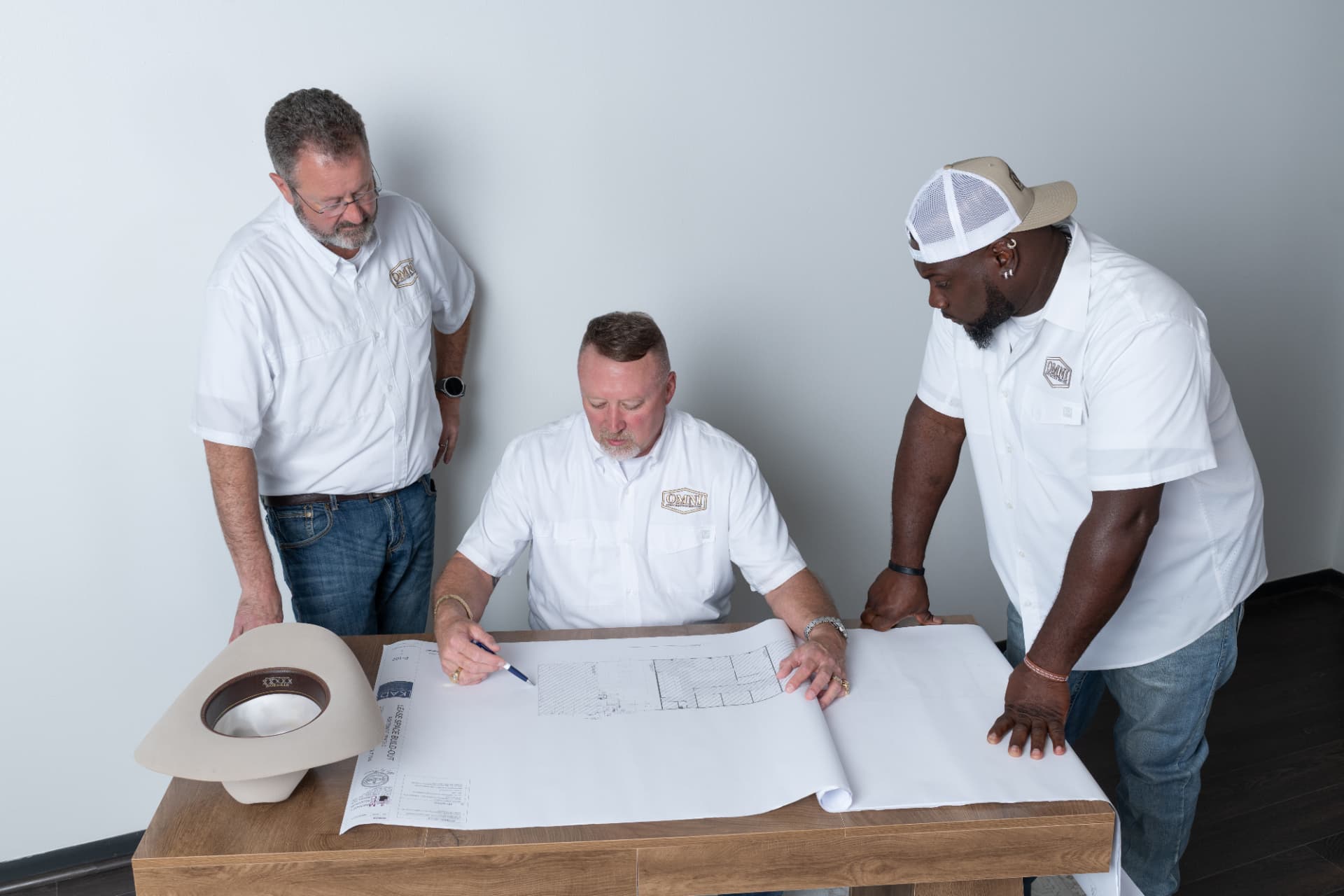 The OMNI Construction team reviewing plans