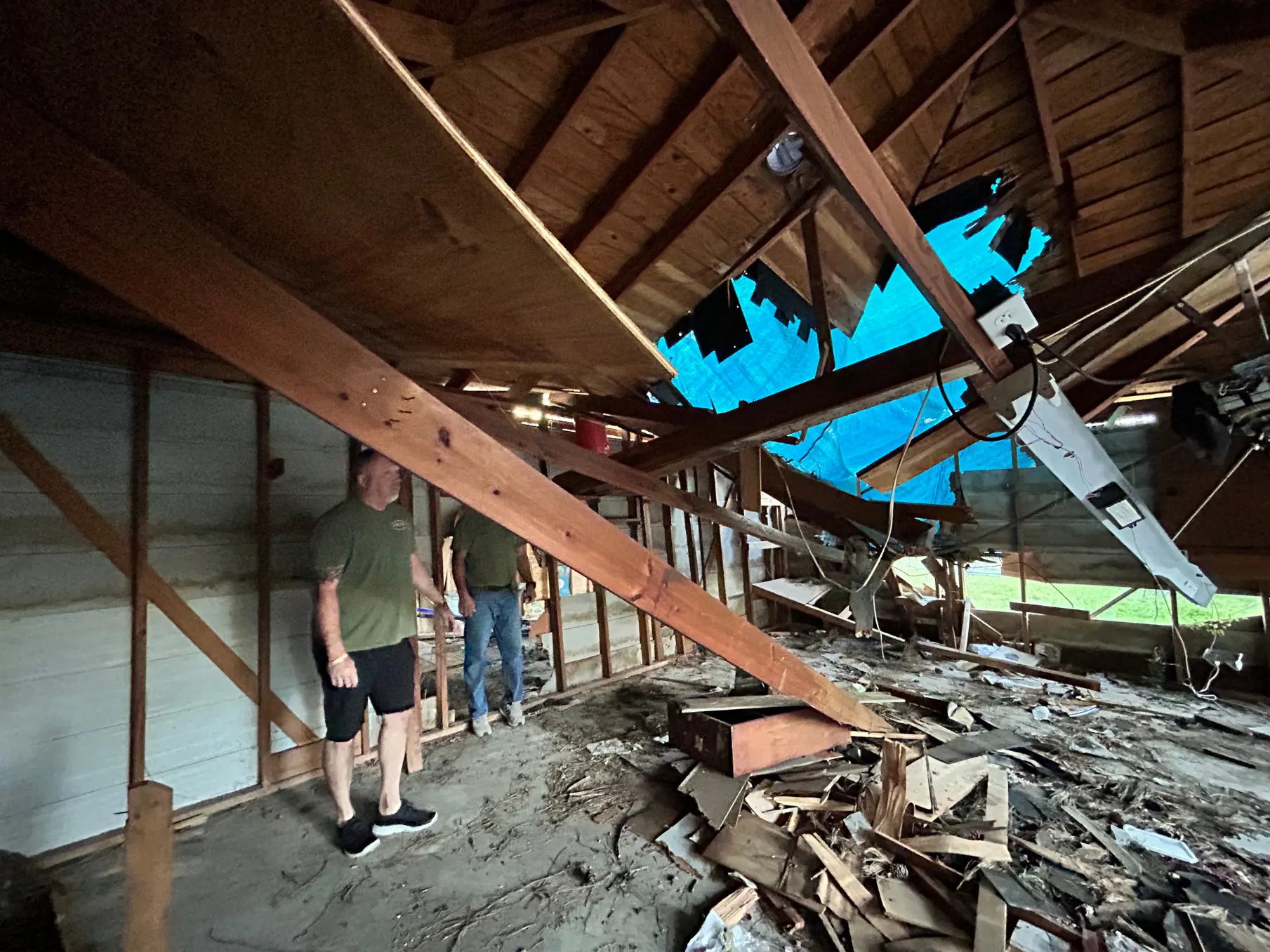 OMNI crew assessing a collapsed ceiling after storm damage