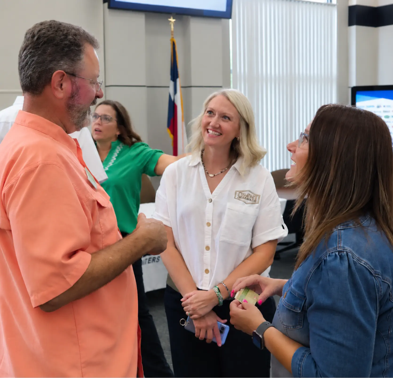 OMNI team members talking with guests at a local business event