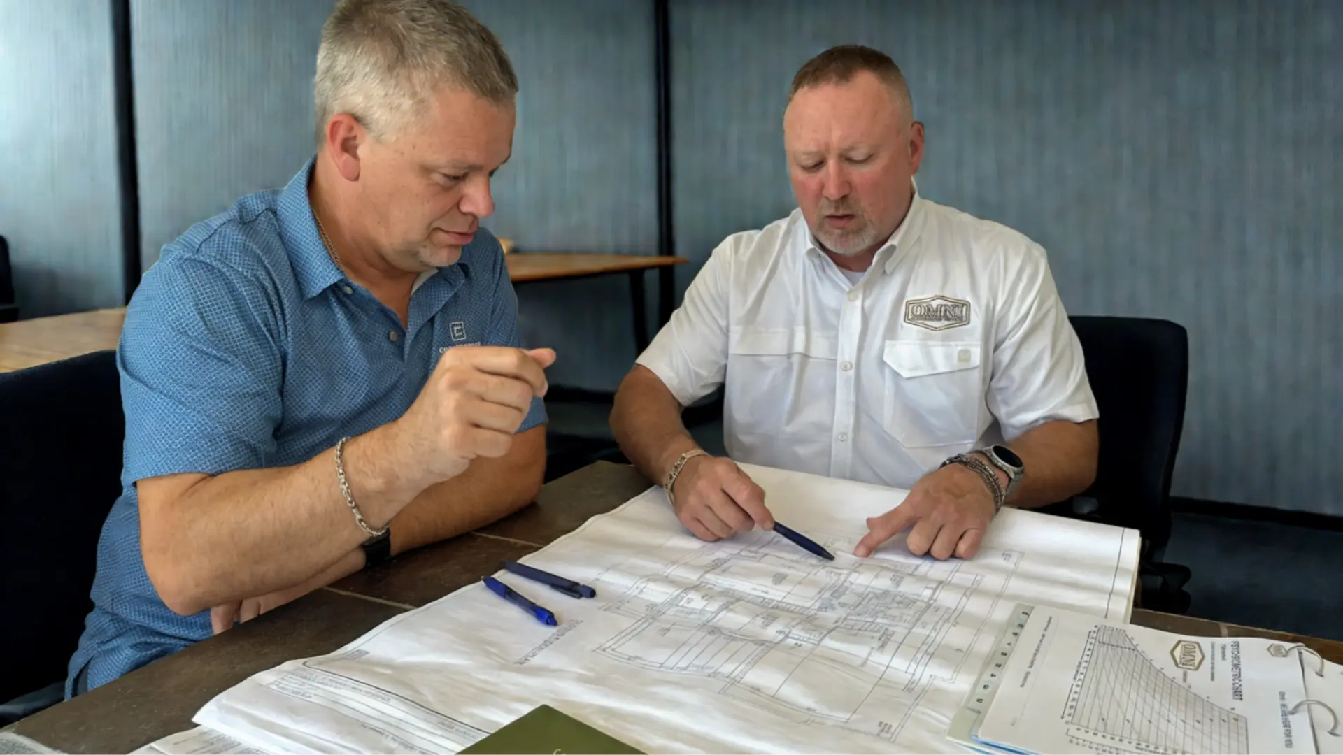 OMNI Construction team reviewing plans with a client
